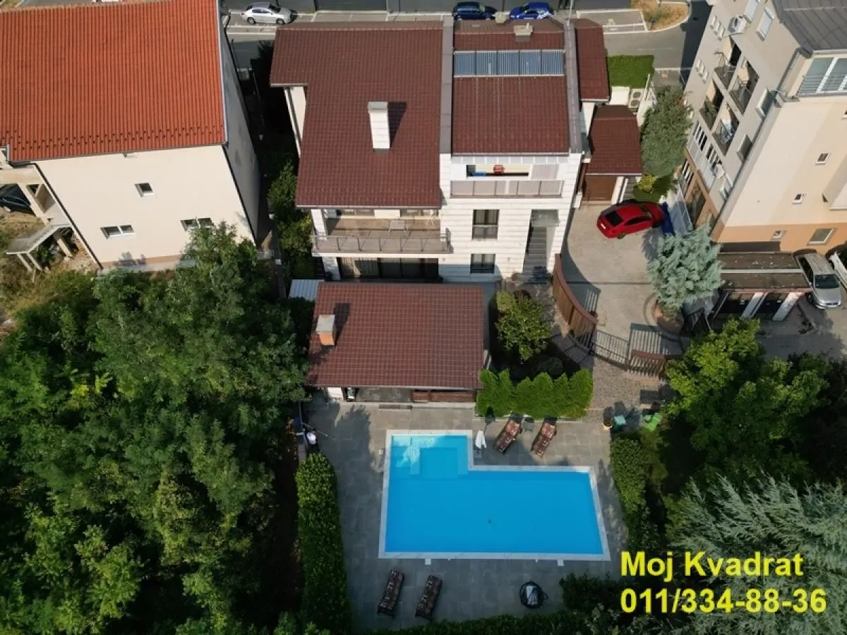 Aerial view of the house with yard and swimming pool.