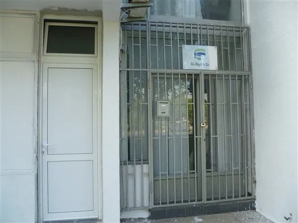 Entrance to a commercial space with metal grates.