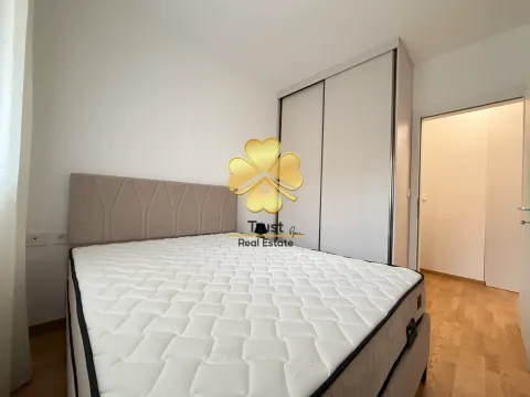 Bedroom with a double bed and built-in wardrobe. - image 12
