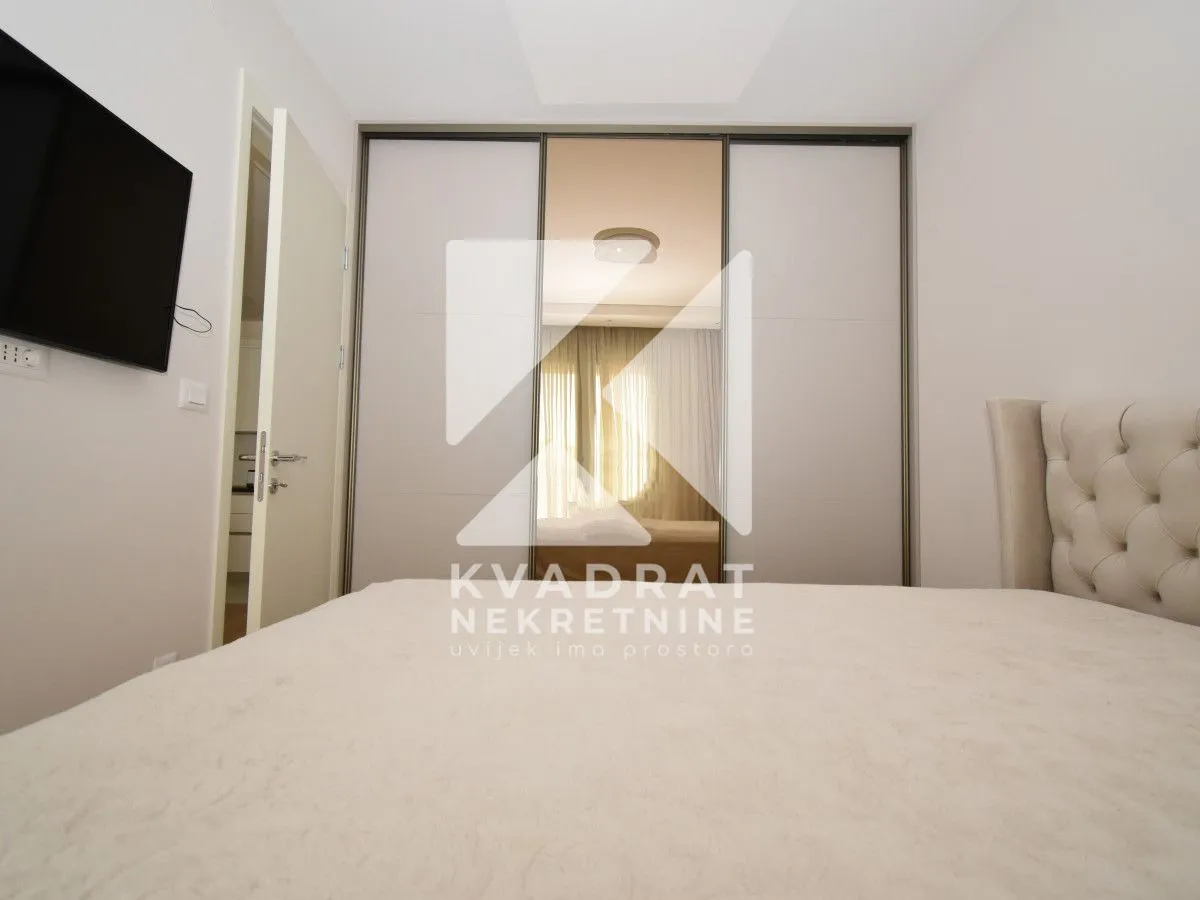 View of a double bed and a large built-in wardrobe in the bedroom.