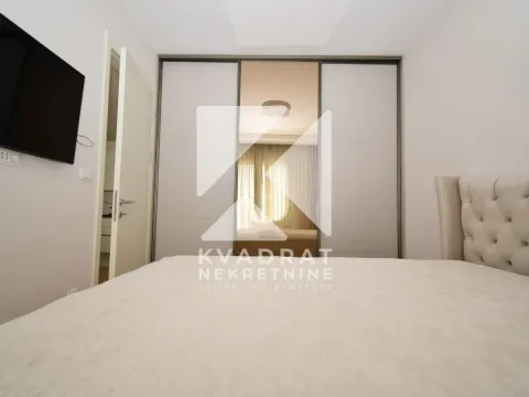 View of a double bed and a large built-in wardrobe in the bedroom. - image 7
