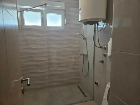 Smaller bathroom with a shower cabin and water heater. - image 9