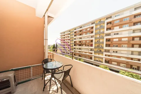 Furnished balcony with seating set and view of surrounding buildings. - image 6