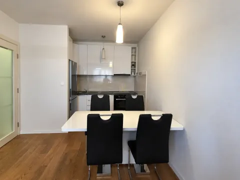Kitchen with dining area and white cabinets. - image 4