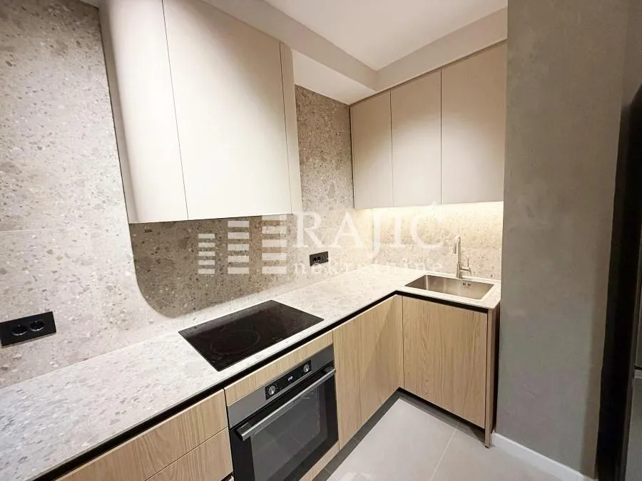 Modern kitchen with built-in appliances and countertops.