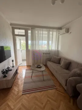 Living room with sofa, TV unit, and access to the balcony. - image 3
