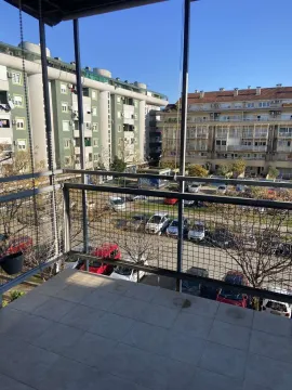 View from the terrace of neighboring buildings and a parking lot. - image 9