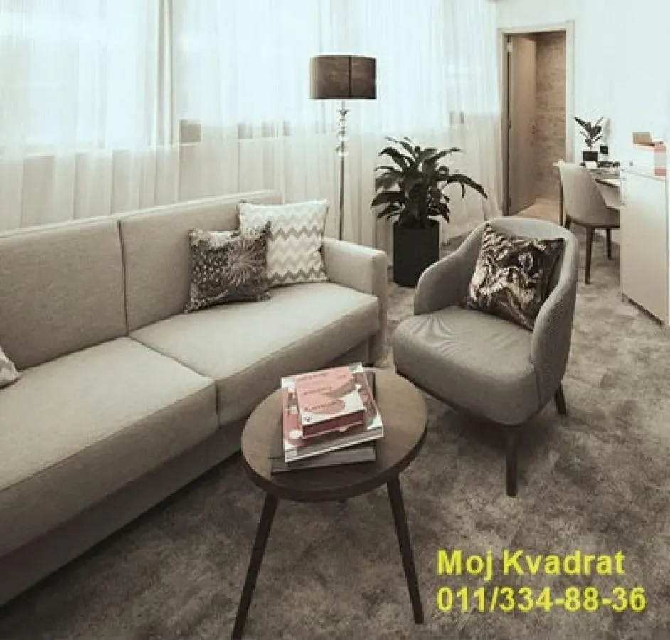 Living room with a sofa, coffee table and armchair.