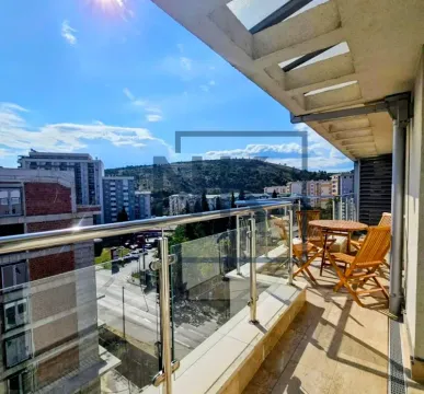 Spacious covered terrace with seating set and city view. - image 13