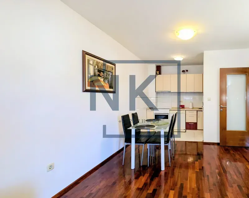 Living room with dining area and open kitchen.