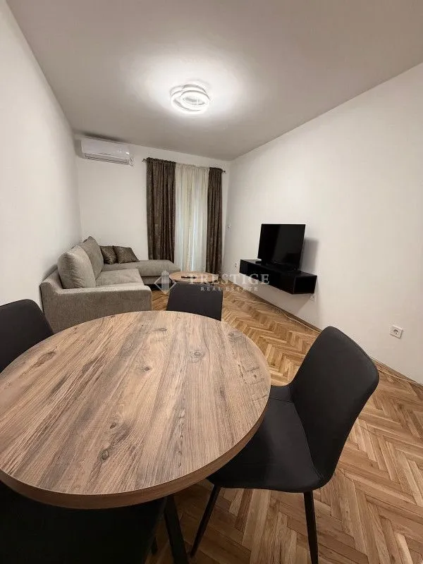 Living room with a dining table and sofa.