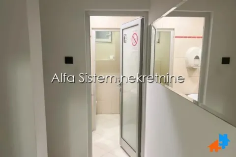 View of the bathroom through an open door from the hallway. - image 12