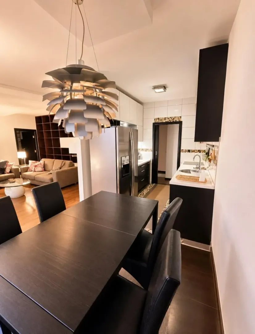 Dining area with a dining table and chairs, connected to the kitchen.