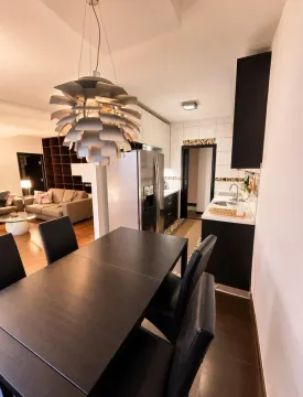 Dining area with a dining table and chairs, connected to the kitchen. - image 4
