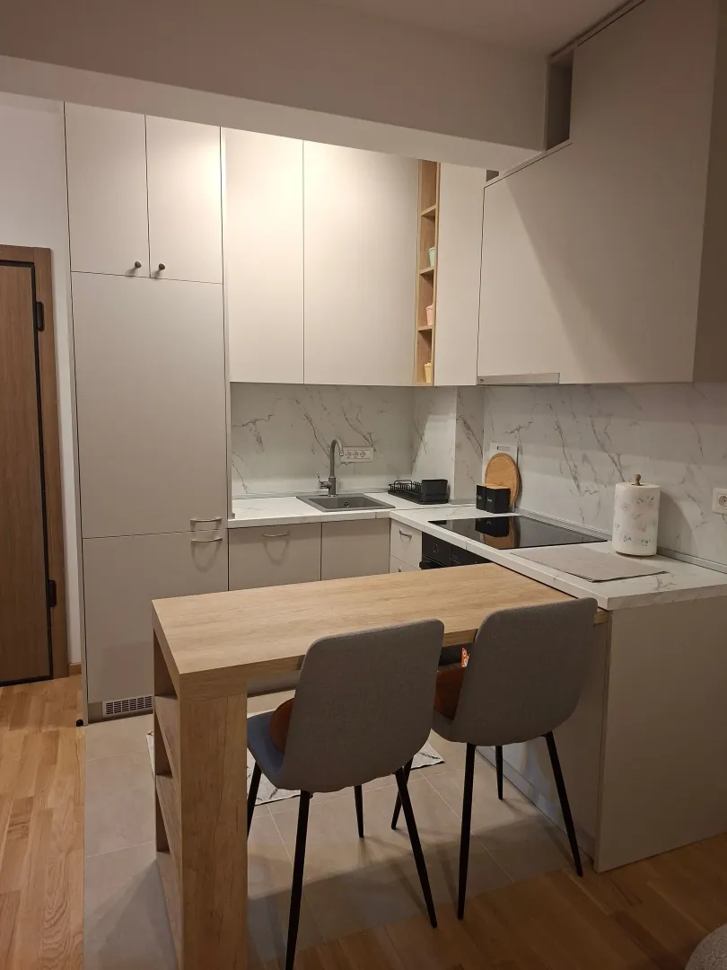 Modern kitchen with a dining table and chairs.