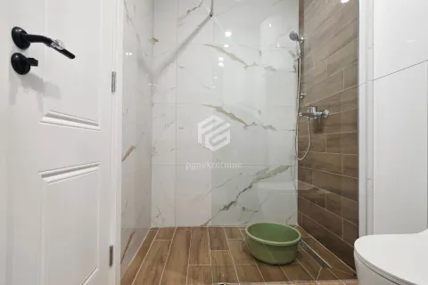 Modern bathroom with a shower cabin and ceramic tiles. - image 6