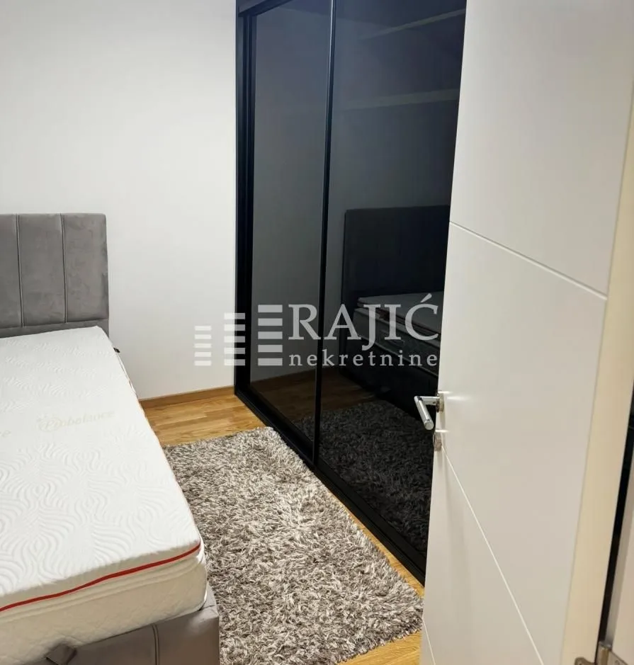 Bedroom with a bed and a large fitted wardrobe.