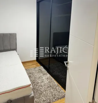 Bedroom with a bed and a large fitted wardrobe. - image 8