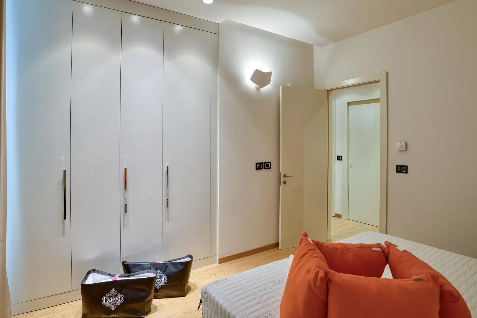 Modern bedroom with a built-in wardrobe and a bed.