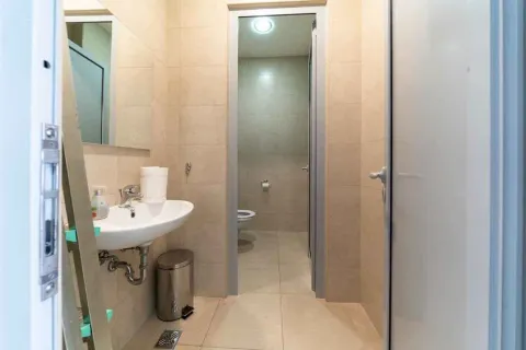 Small bathroom with a washbasin, mirror, and toilet in the background. - image 13
