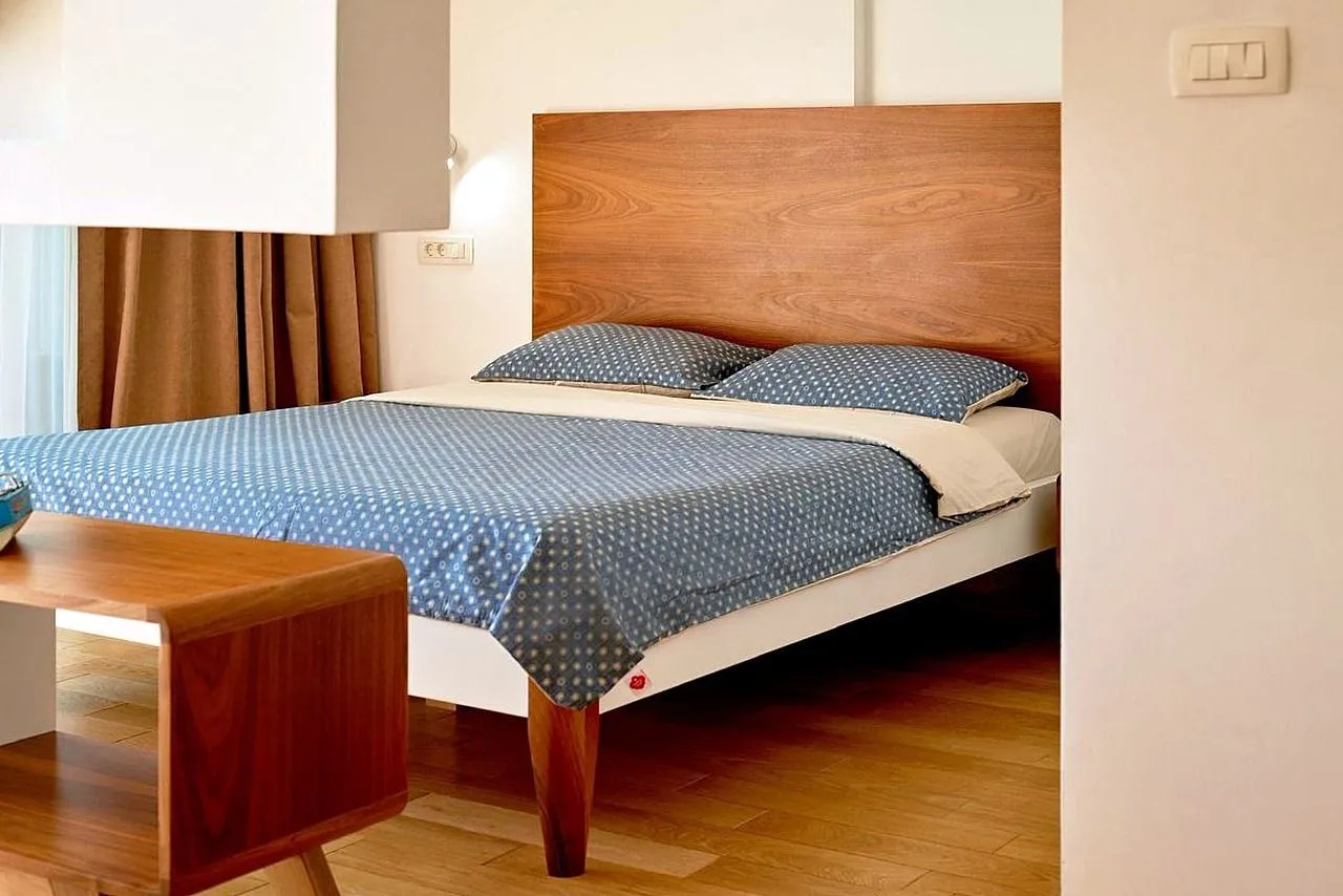 Bedroom with a double bed and wooden headboard.