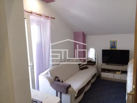 Living room with a sofa and television. - image 9