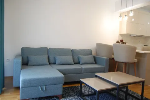 Living room with a sofa and a view of the kitchen. - image 10