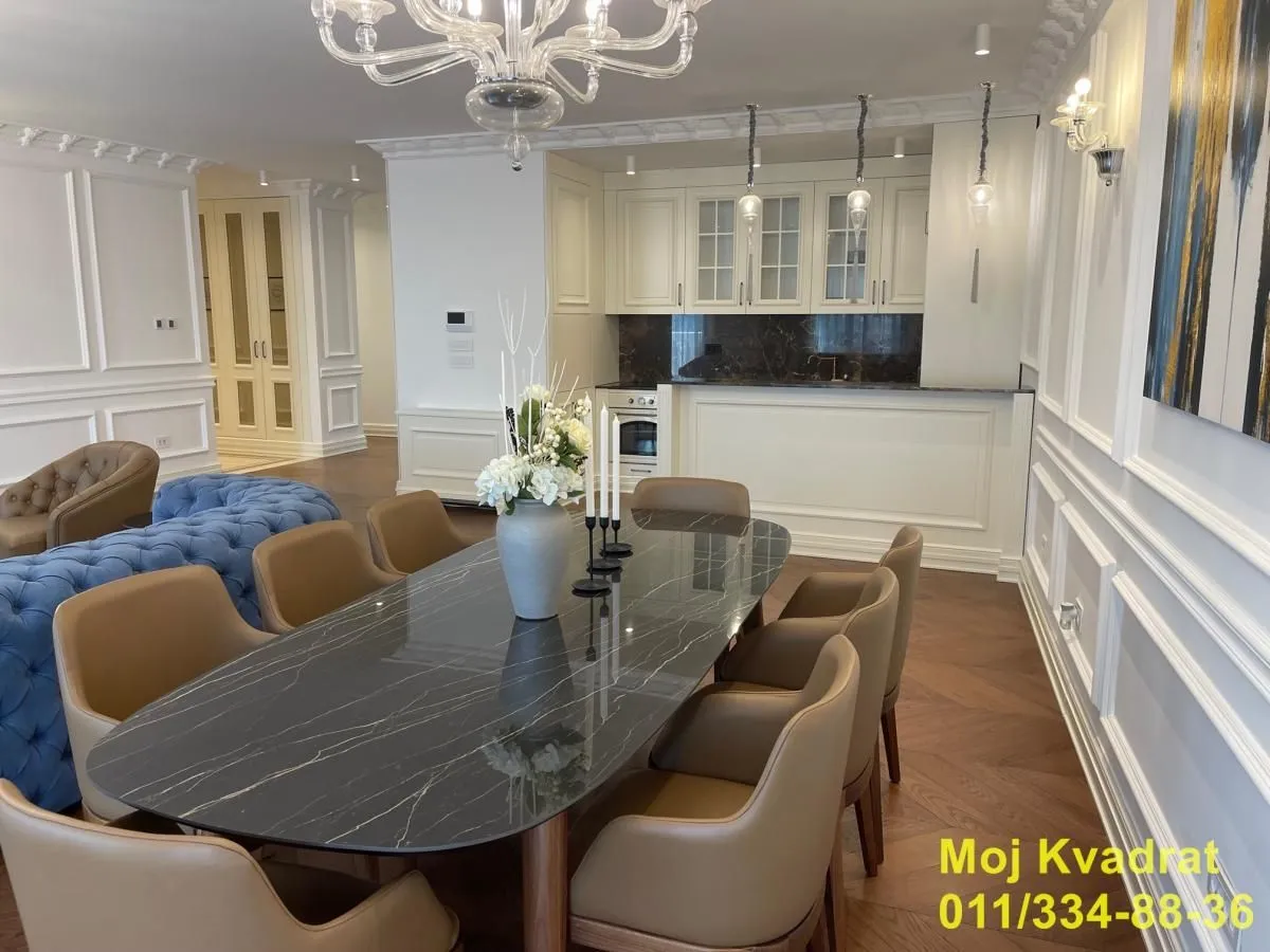 Spacious living room with dining area and kitchen in the background.