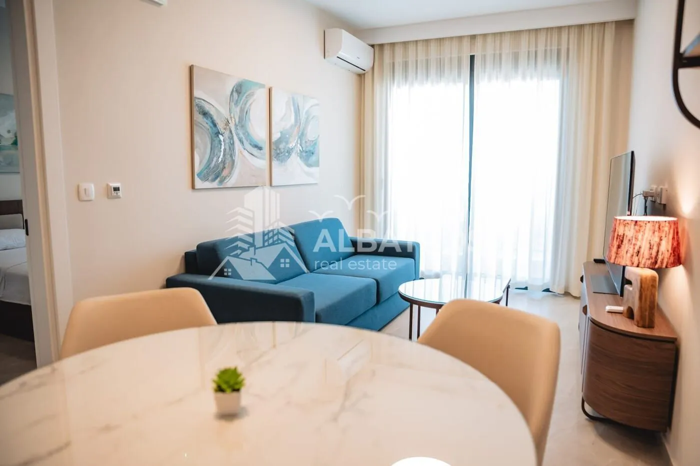 Living room with a sofa and dining table.