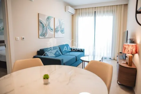 Living room with a sofa and dining table. - image 4
