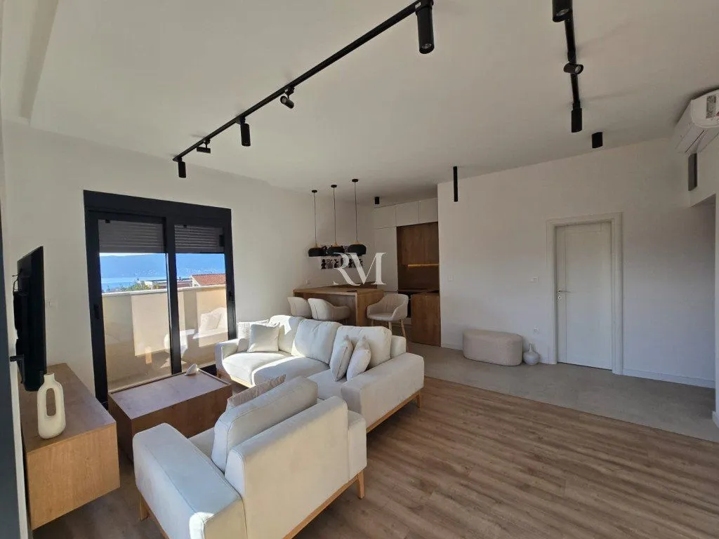 Modern living room connected to the dining area and kitchen.