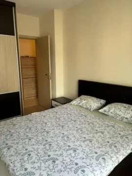 Furnished bedroom with a double bed, wardrobe, and an open door leading to a storage room. - image 7