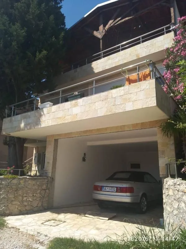 View of the house facade with a garage and terrace.