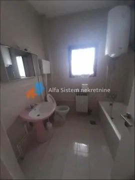 Bathroom equipped with a bathtub, washbasin, toilet, and water heater. - image 19