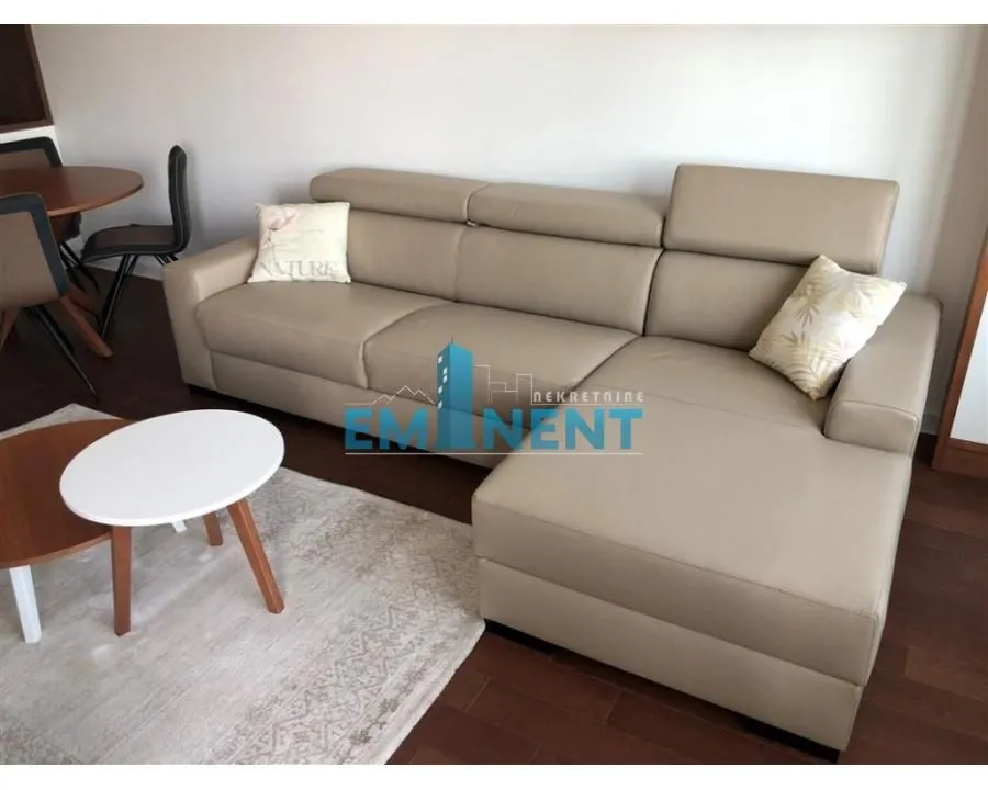 Living room with a beige sofa and a small coffee table.