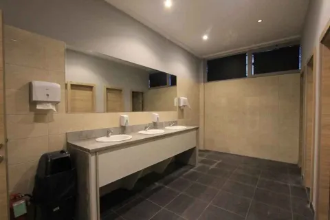 Public bathroom with washbasins and a mirror. - image 14