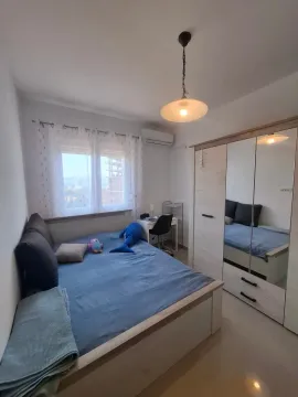 Children's bedroom with a bed, desk, and a large mirrored wardrobe. - image 2
