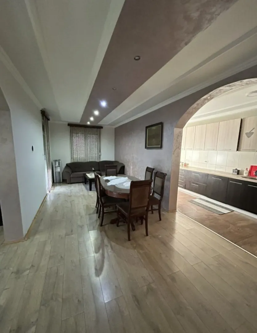 Spacious living room with dining area and a view of the kitchen.