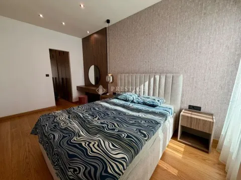 Modern bedroom with a double bed, wooden elements and built-in wardrobes. - image 11