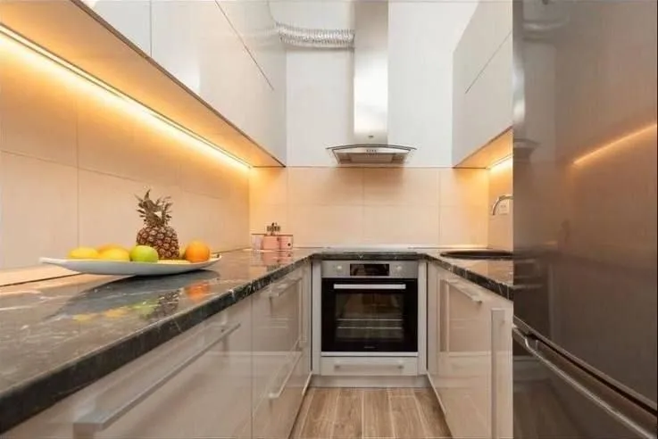 Modern and tidy kitchen with a built-in oven and fitted cabinets.