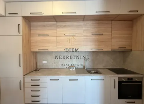 Modern kitchen with white and wood-finish cabinetry. - image 7