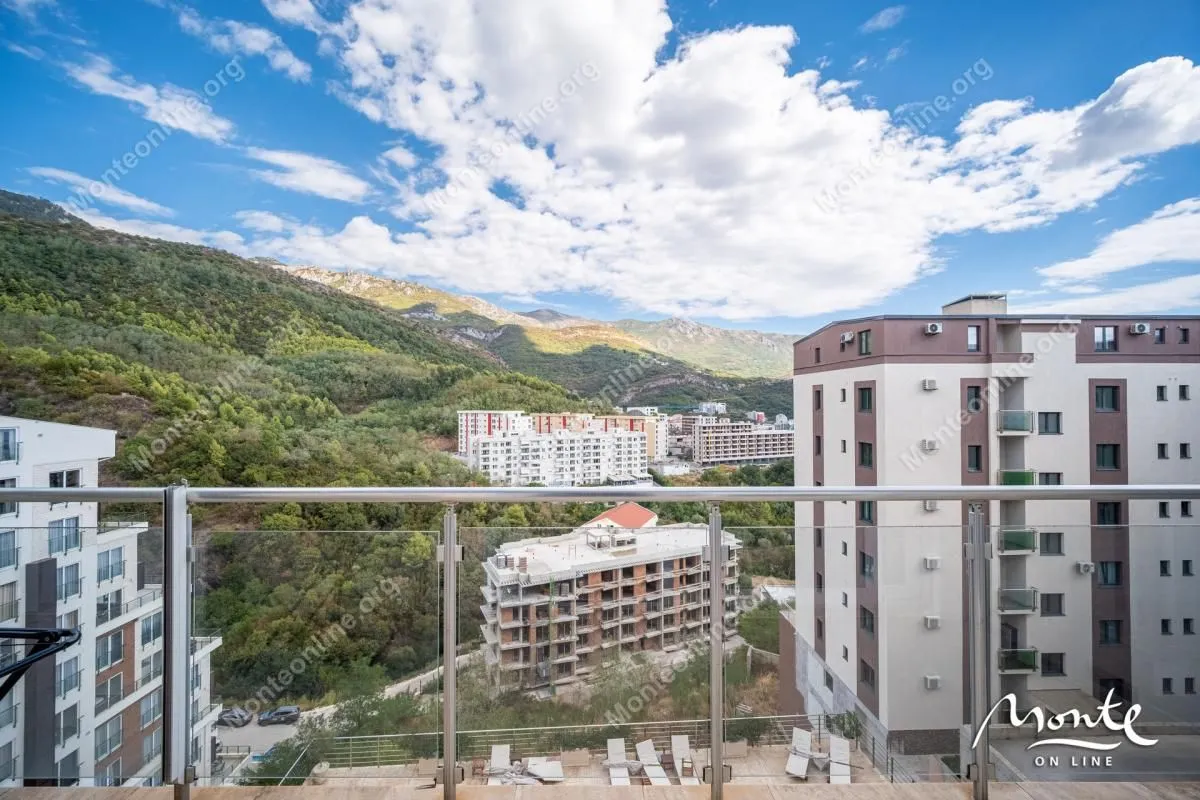 View of the mountains and surrounding buildings from the terrace.
