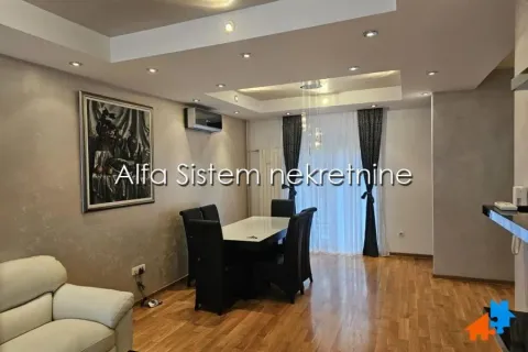 Living room with a dining area and parquet flooring. - image 3