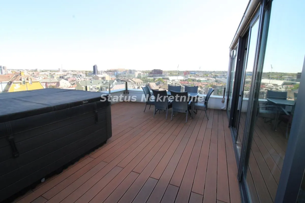 Spacious terrace with seating furniture and a city view.