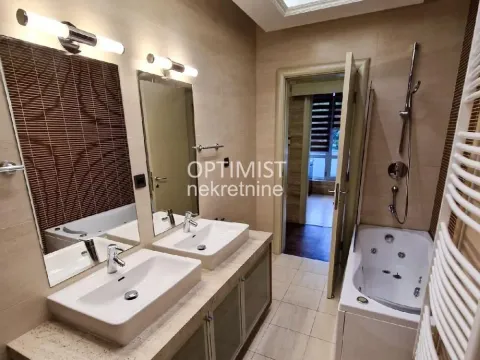 Bathroom with two sinks, mirrors, and a hydromassage bathtub. - image 6