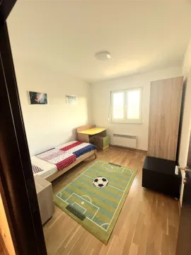 Children's bedroom with a bed, desk, and wardrobe. - image 3