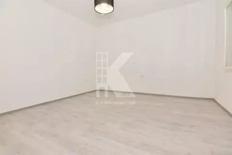Empty room with white walls and laminate flooring. - image 7