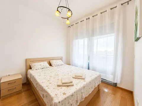 Bright bedroom with a double bed and a nightstand. - image 5