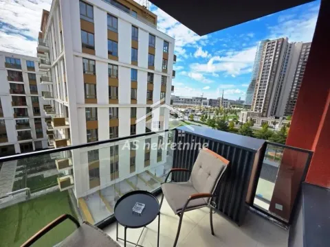 Furnished balcony with a table and chairs, offering a view of surrounding buildings and the city. - image 13