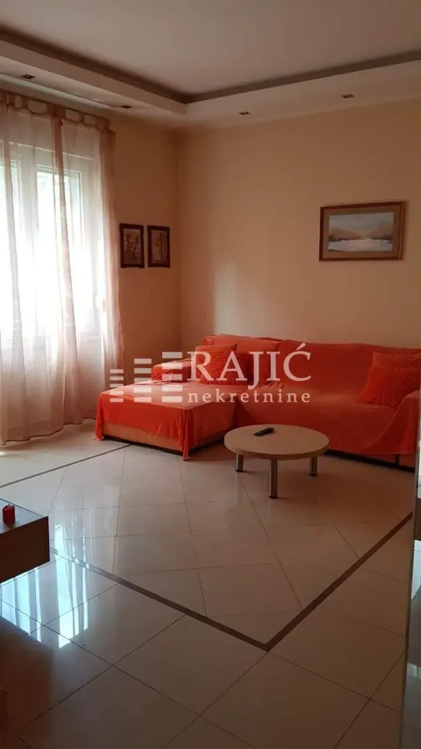 Living room with a sofa set and ceramic flooring.